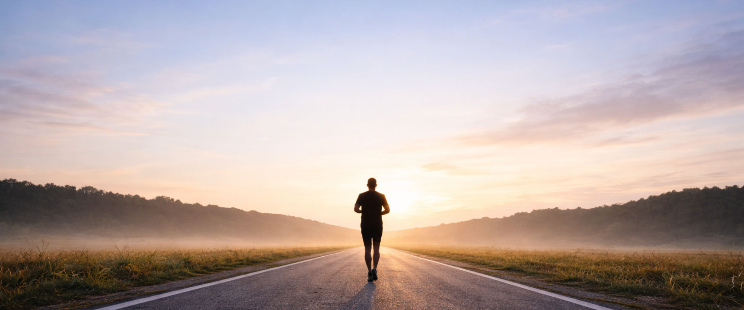 Corredor solitário ao amanhecer em uma estrada, simbolizando jornada e reconstrução.
